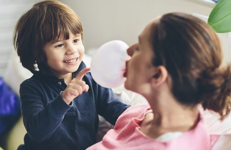 Little boy popping bubble-gum balloon