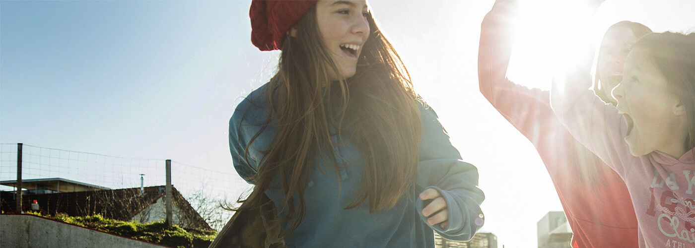 Joyful young woman in the sunshine. See Yoplait YOP Fuel products.