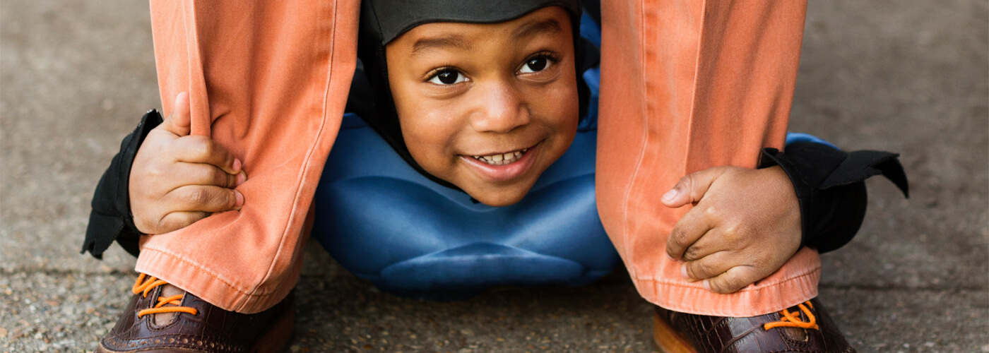 Child holding onto their parents shoe